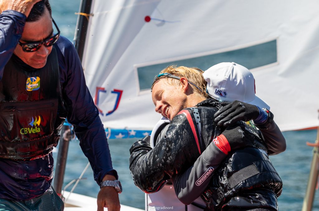 Sailors hugging after Brazil comes away with regatta win