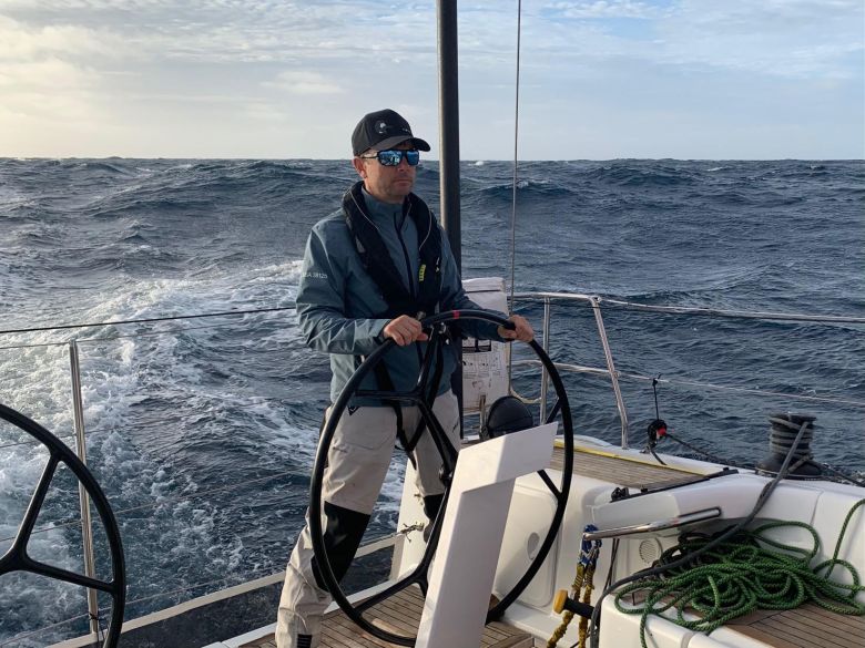 Sailor behind wheel offshore