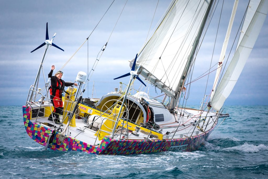 Lisa Balir sailing, waving at camera