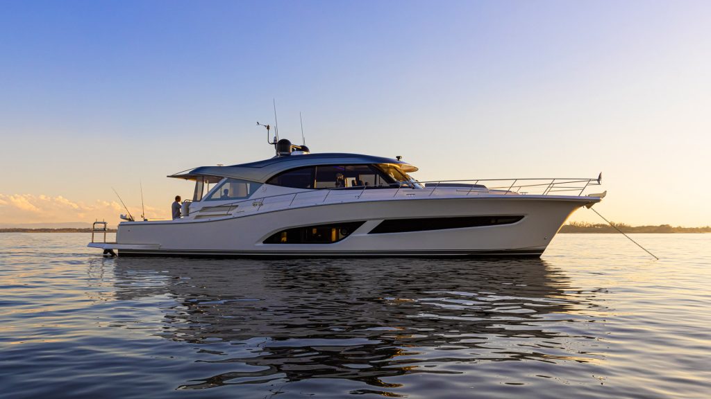 A Riviera motor boat at anchor at sunset