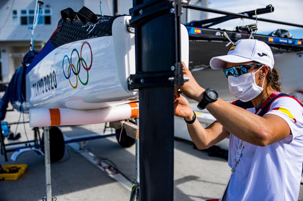 Nacra sailor checking her boat on shore 