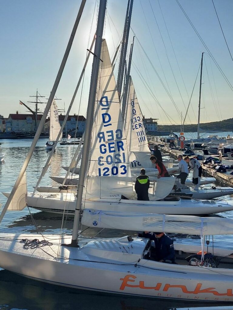 Sailors preparing their boats on the dock.