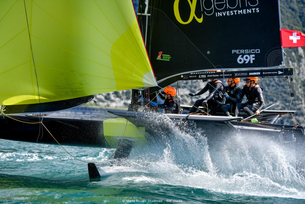 Side view of a boat on foils with spinnaker up. 