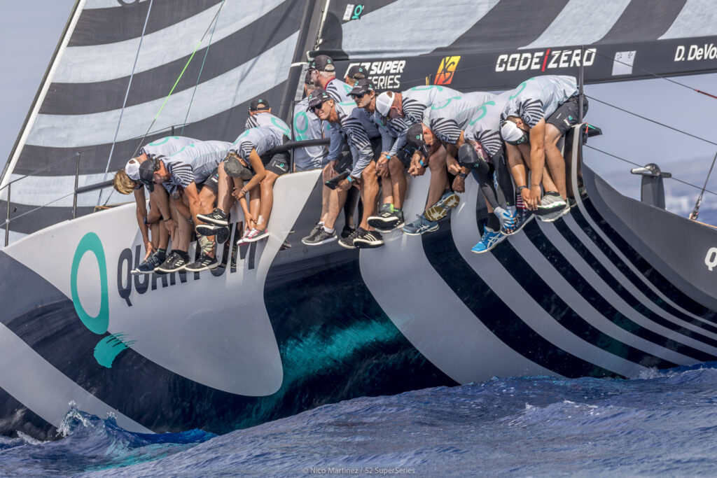 Quantum Racing healing on the upwind, all the crew are hiking over the side of the boat.