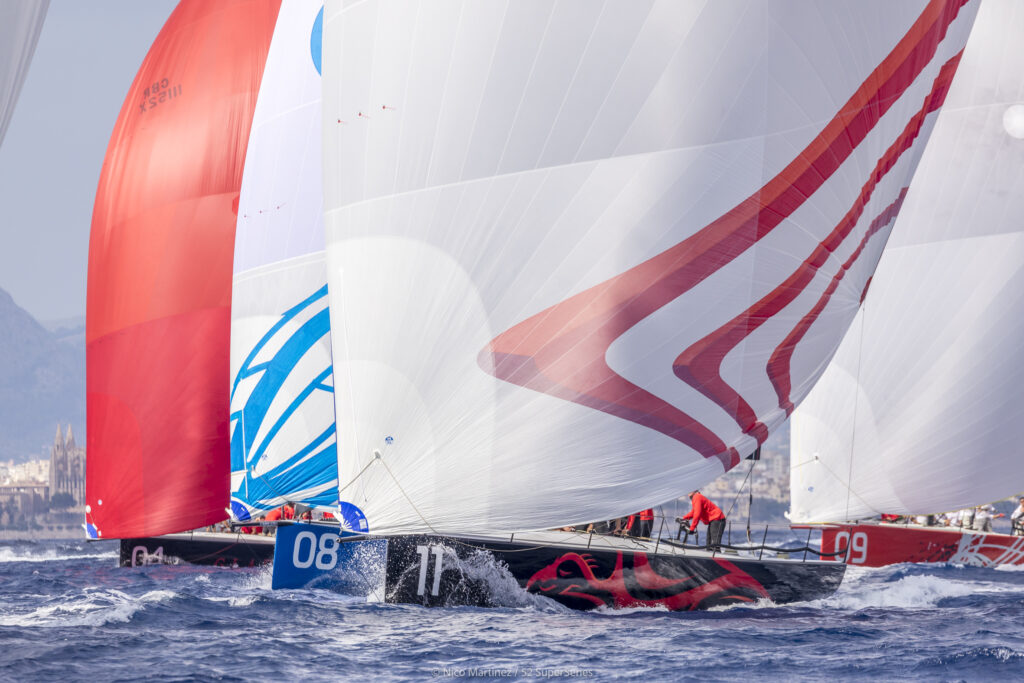 Phoenix sailing downwind with the kite up and the three boats are right on her heels.