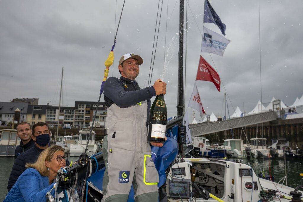 Pierre Quiroga spraying champagne on the dock, celebrating his win.