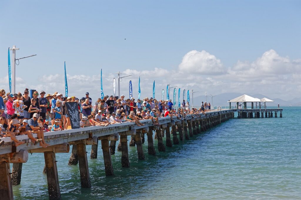 Spectators await the race on the pier.