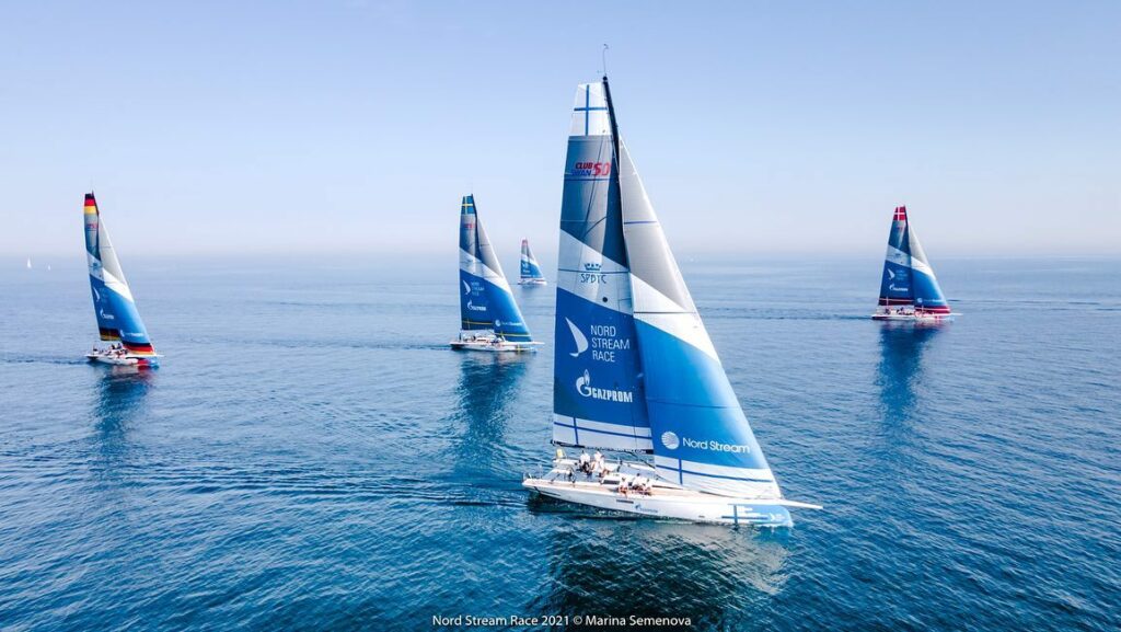 Aerial shot of the fleet racing in flat water. 