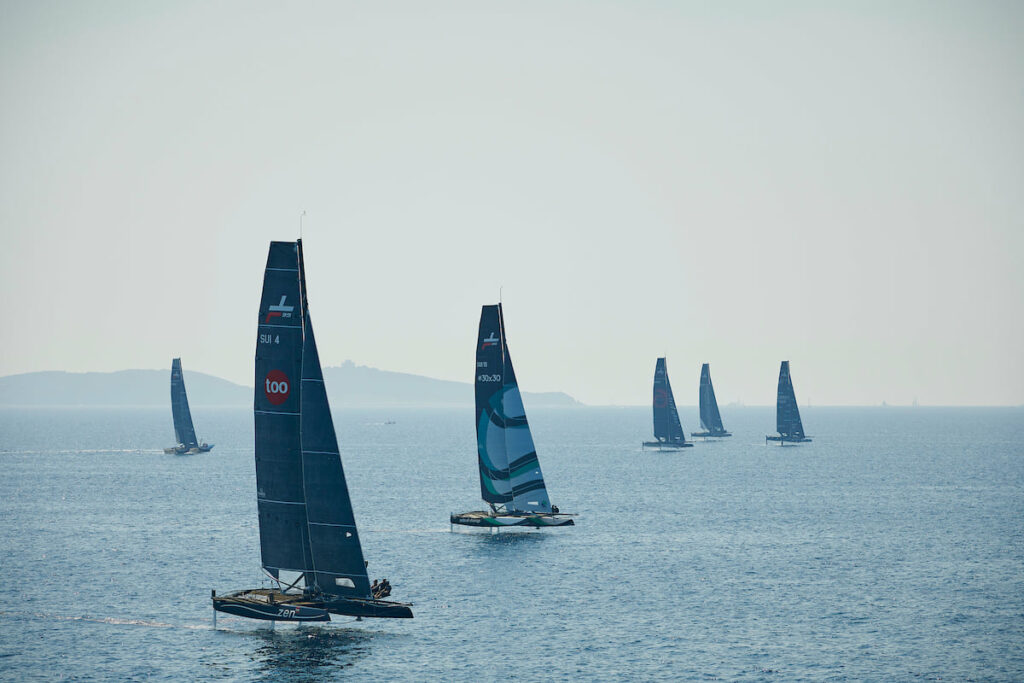 The fleet sailing upwind on a hazy day.