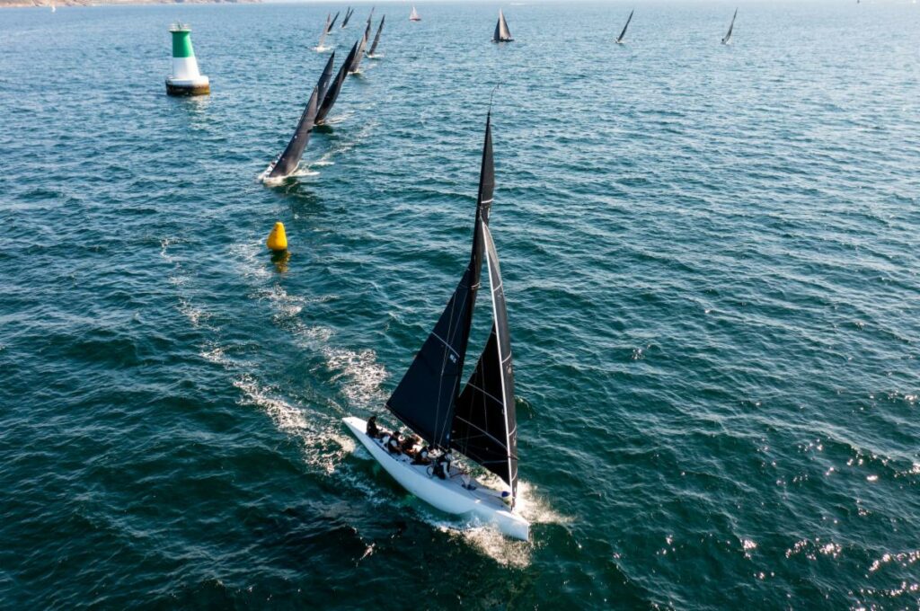 Aerial shot of the fleet rounding a yellow marker.