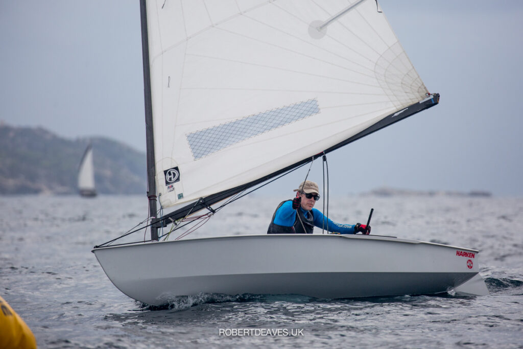 Andy Dalby sailing downwind, about to pull boom across.