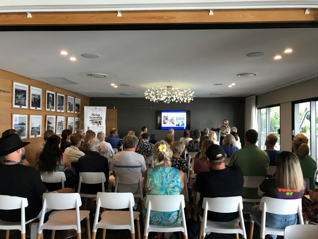 People presenting to an audience sitting down.