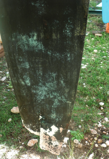 A damaged rudder on dry land.