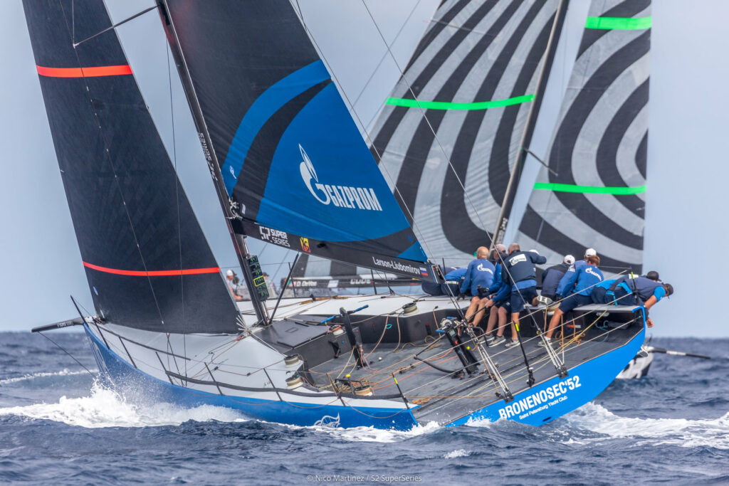 Bronenosec sailing upwind. Crew leaning over the side. Another boat passing on the other tack in front.