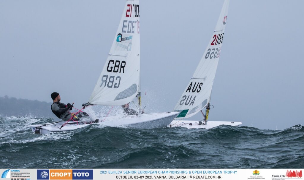 A GBR and Aussie sailor over the peak of a wave.