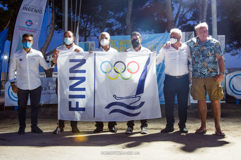 Six officials holding a Finn flag at the Opening Ceremony.