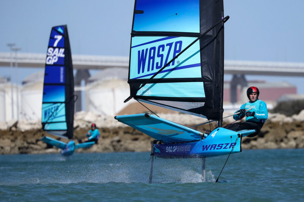 Two waszp sailors with a bridge in the background.