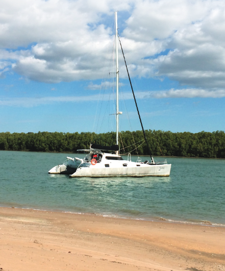 Catamaran anchored off a beach.