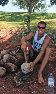 Someone drilling a hole through a coconut.