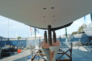 Boat on the dock, keel mid being attached.