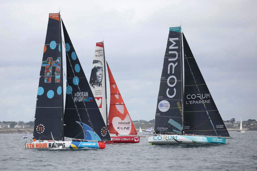 Three IMOCAs sailing upwind.