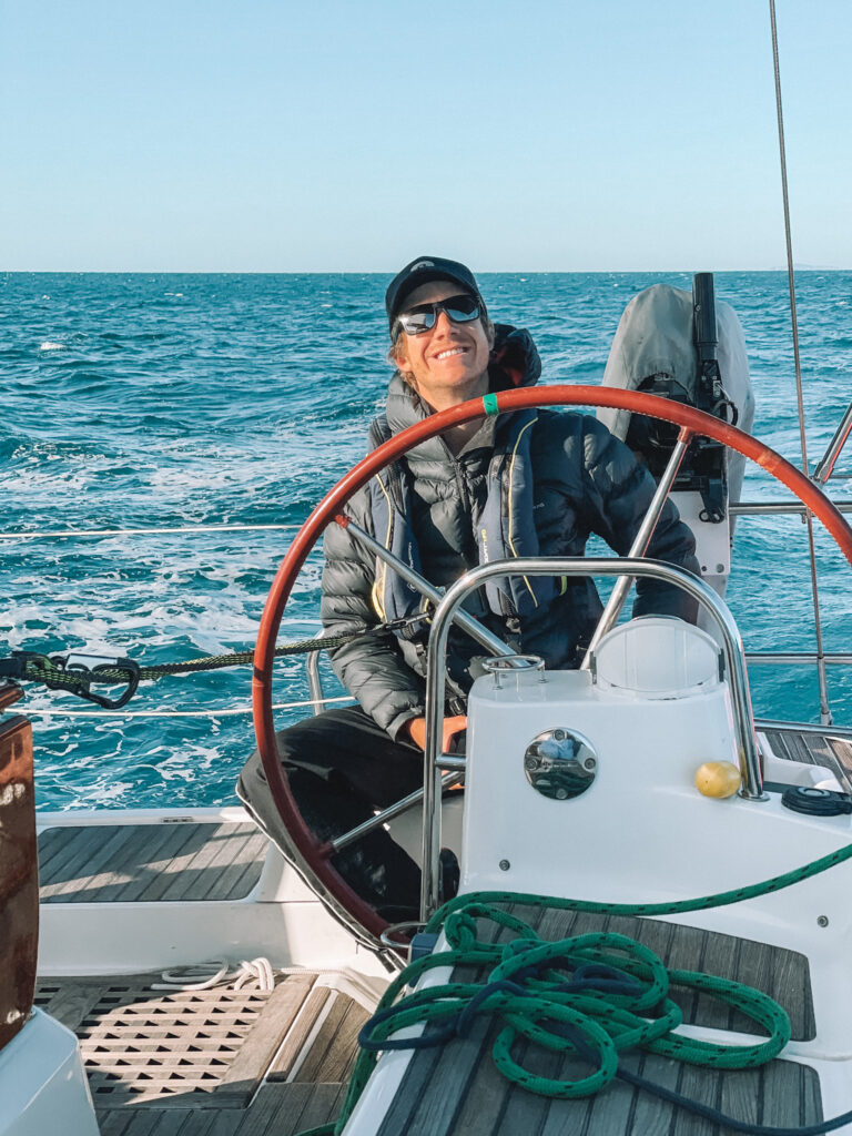 John Tilley  behind the wheel of the boat.