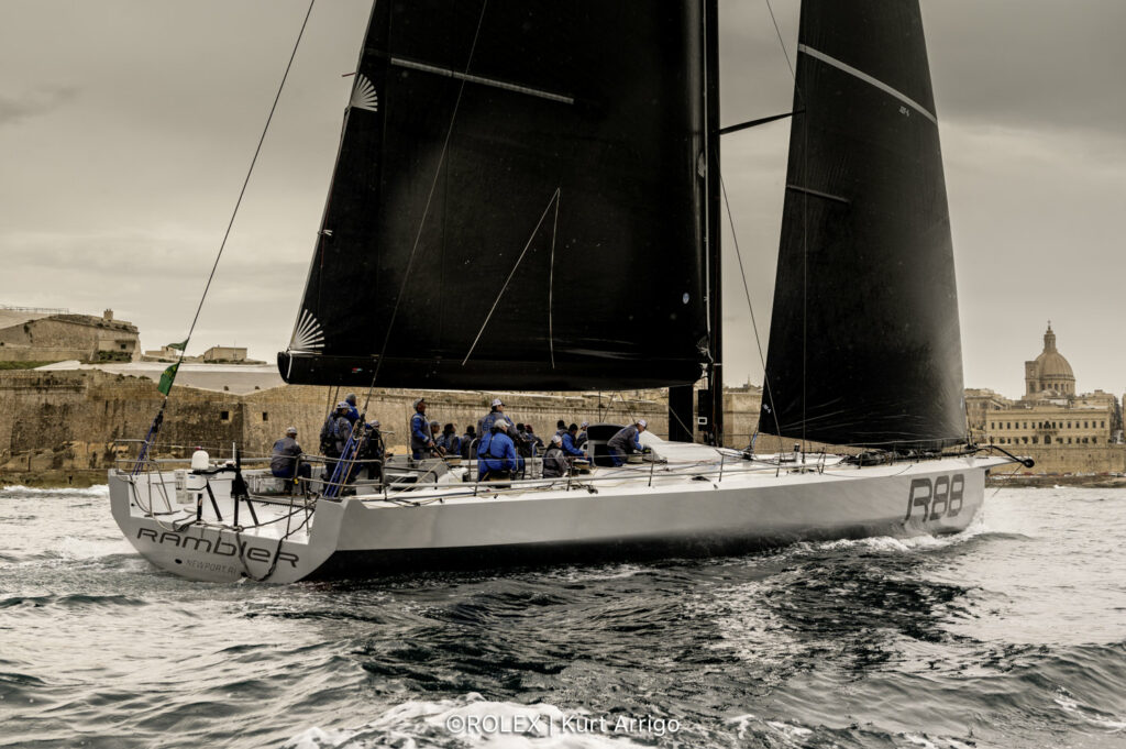 Rambler sailing past land and sandstone buildings into Malta.