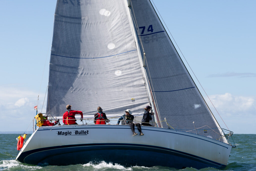 Magic Bullet sailing upwind. Crew on the side.