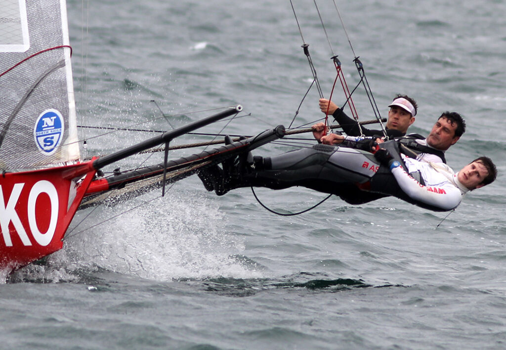 Crew all leaning out on 18 while sailing upwind.