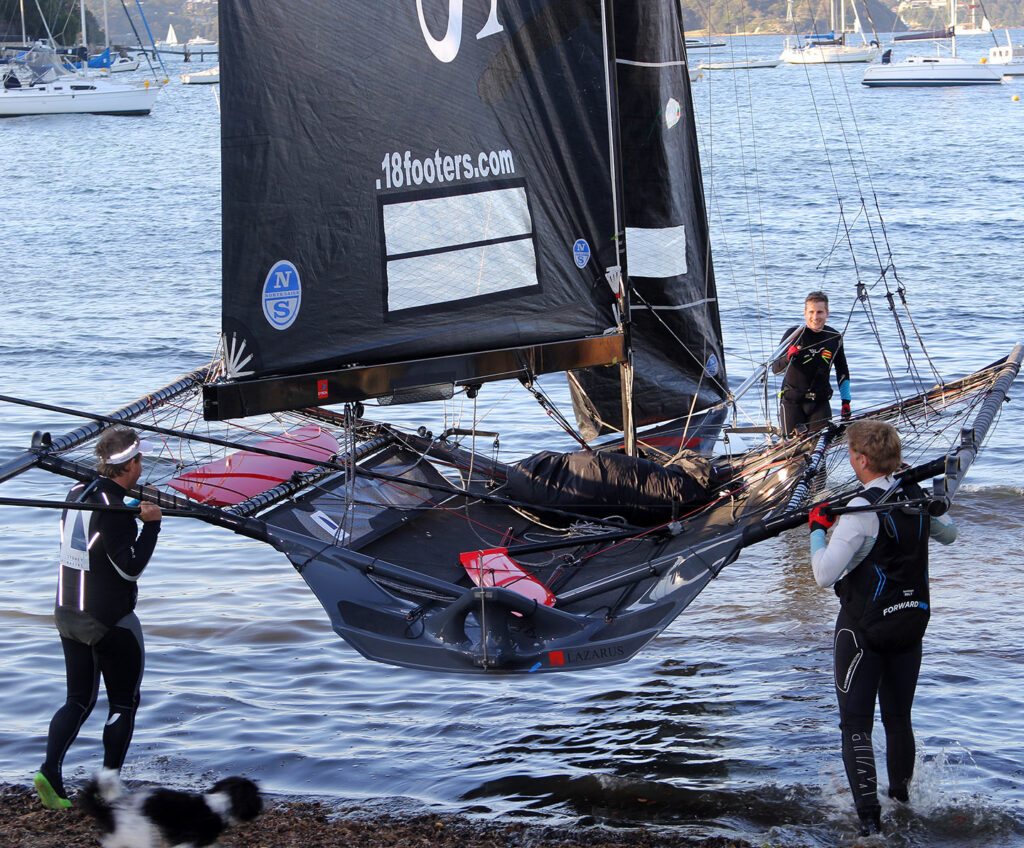 The crew carry Lazarus Capital Partners 18 into the water