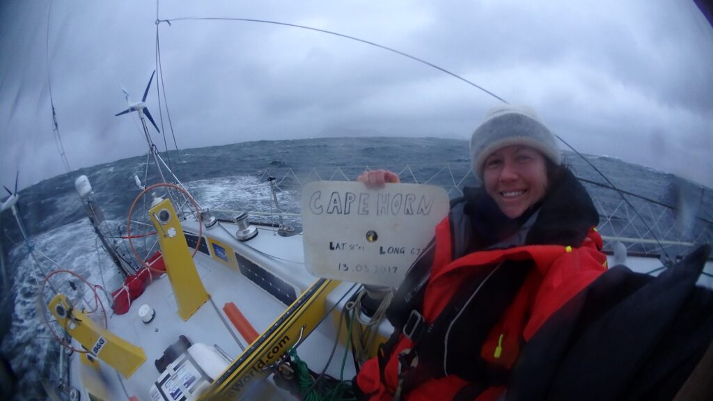 Lisa Blair holding up a cape Horn poster.