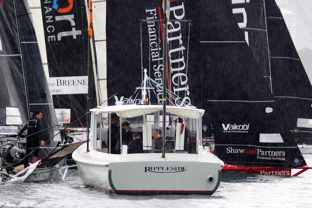 Skiffs surround the star boat.