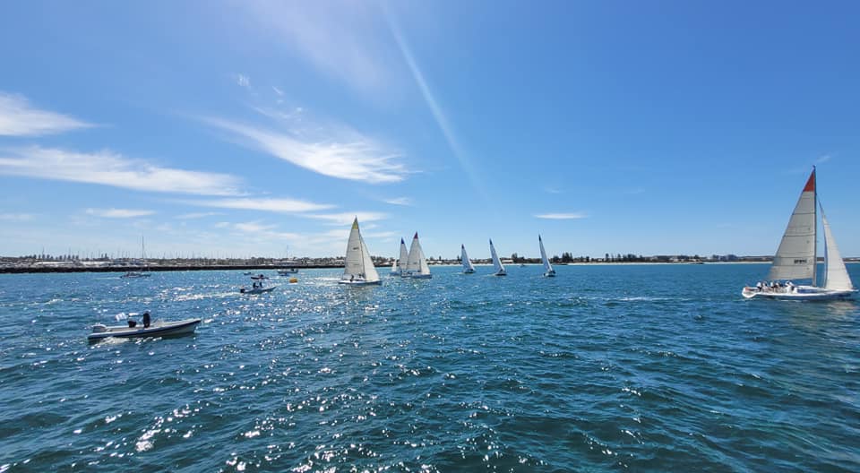 Fleet splitting after start, sailing upwind.