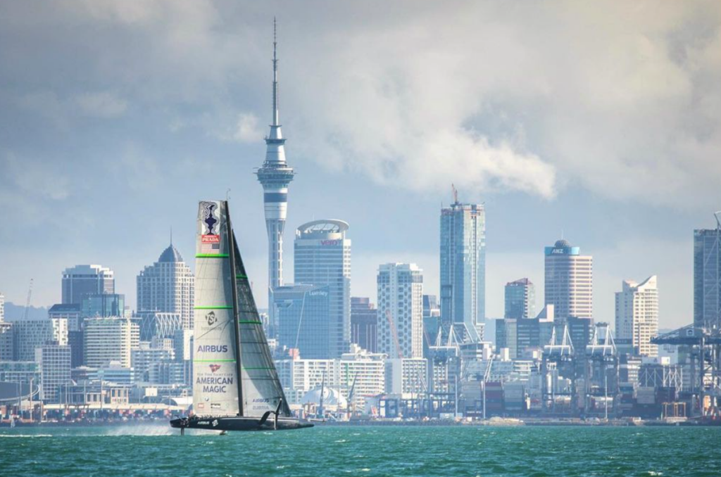 American Magic foiling with city in the background.