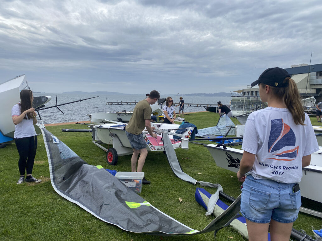 People rigging their boats in the boat park, looking onto Lake Macquarie.