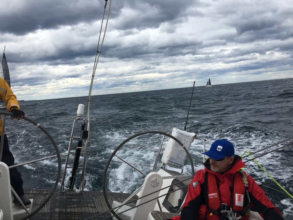 Looking onto the back half of the cockpit, main trimmer and helmsman. 