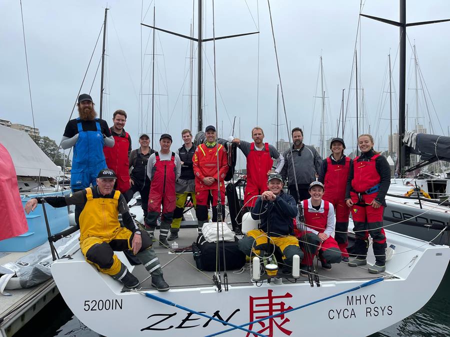 Zen crew smiling on deck of the yacht while on the boat.