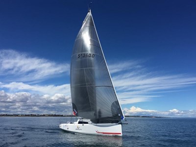 Maverick sailing, whispy cloud formation behind.