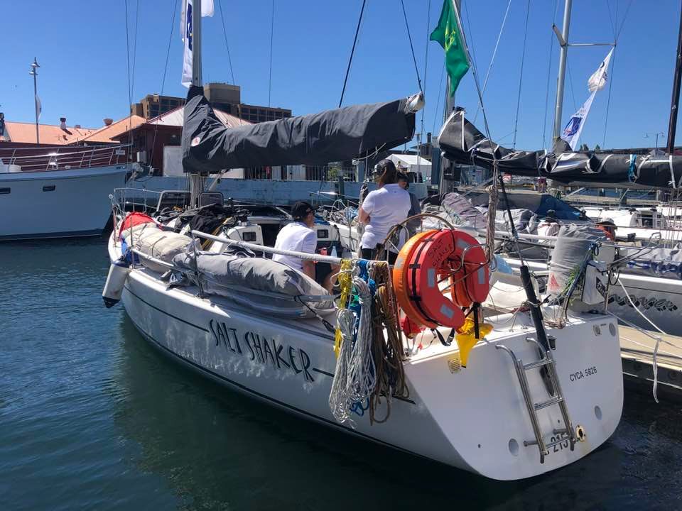 Salt Shaker tied to the dock. People sitting on board.