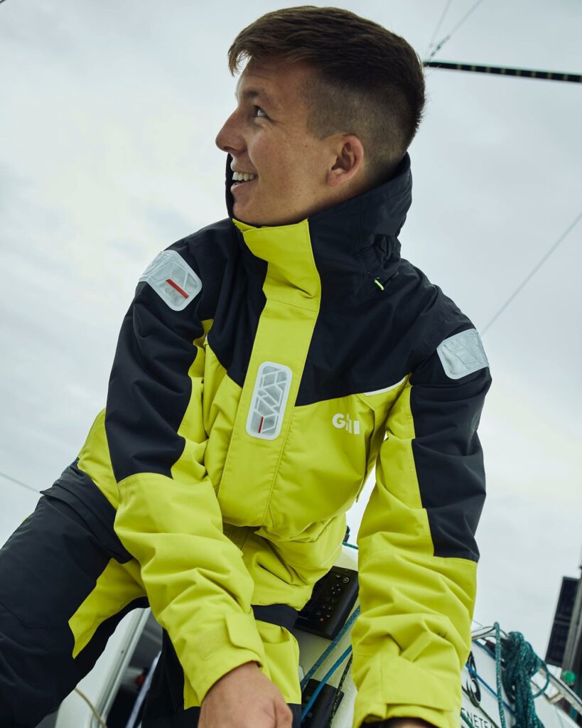 Paddy on a boat in his yellow and black wet weather gear.