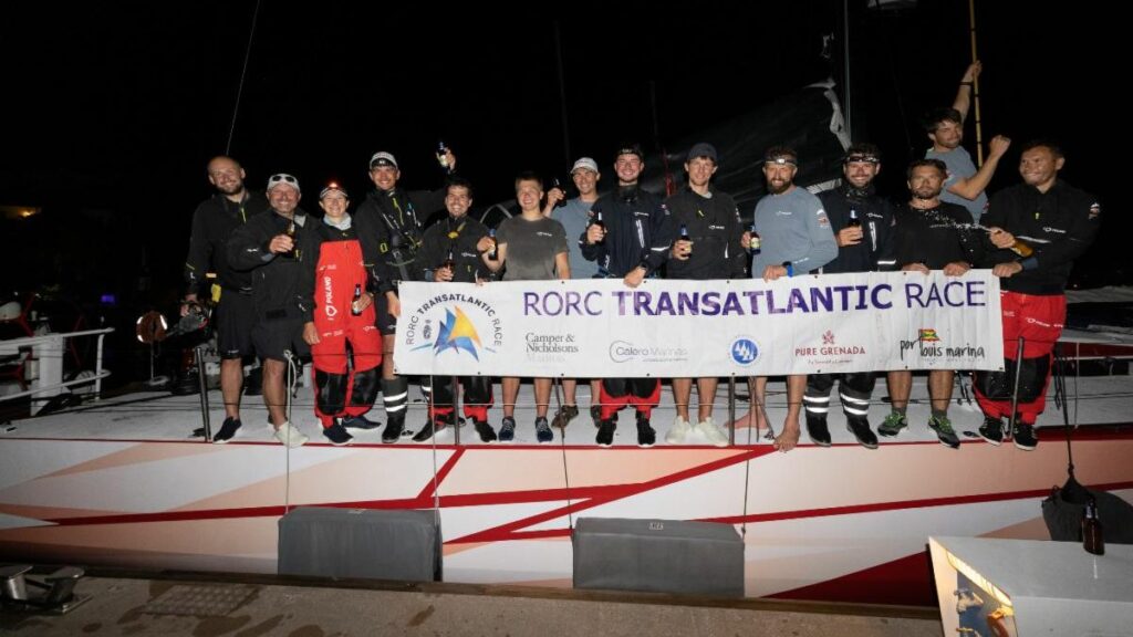 I Love Poland holding banner on the boat, celebrating, while tied to the dock.