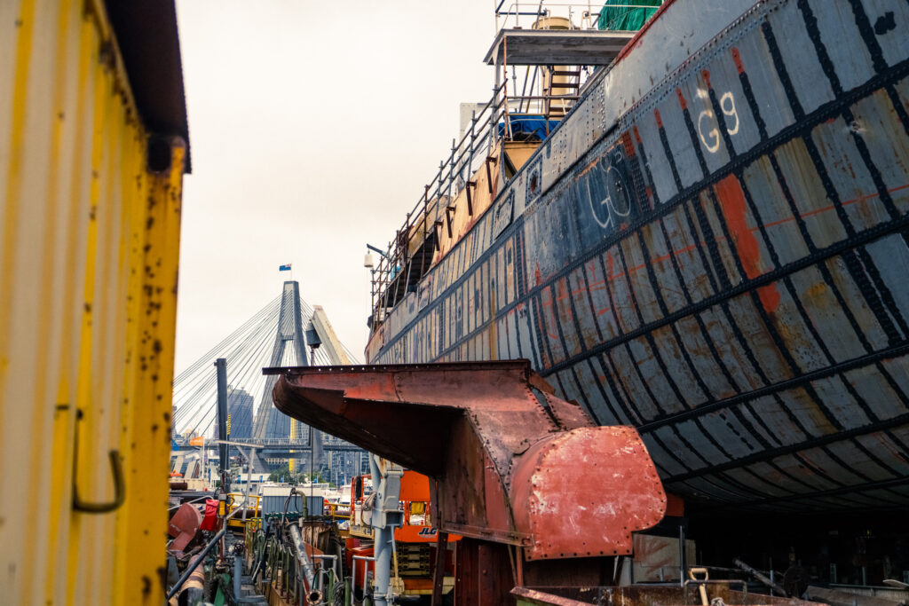 Anzac bridge, taken from a boat yard, with boats on hardstand in view.