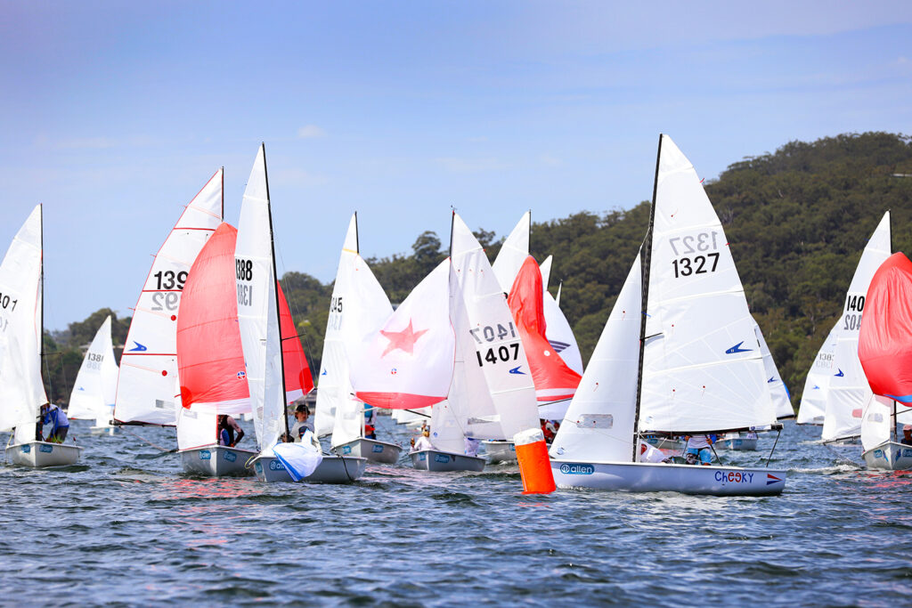 Boats approaching mark with kites up or dropping or have dropped their kites.