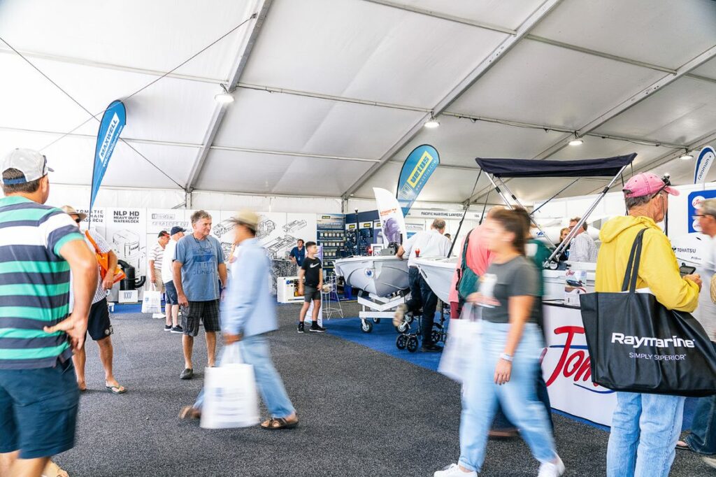 People walking, blurred, in a huge tent.