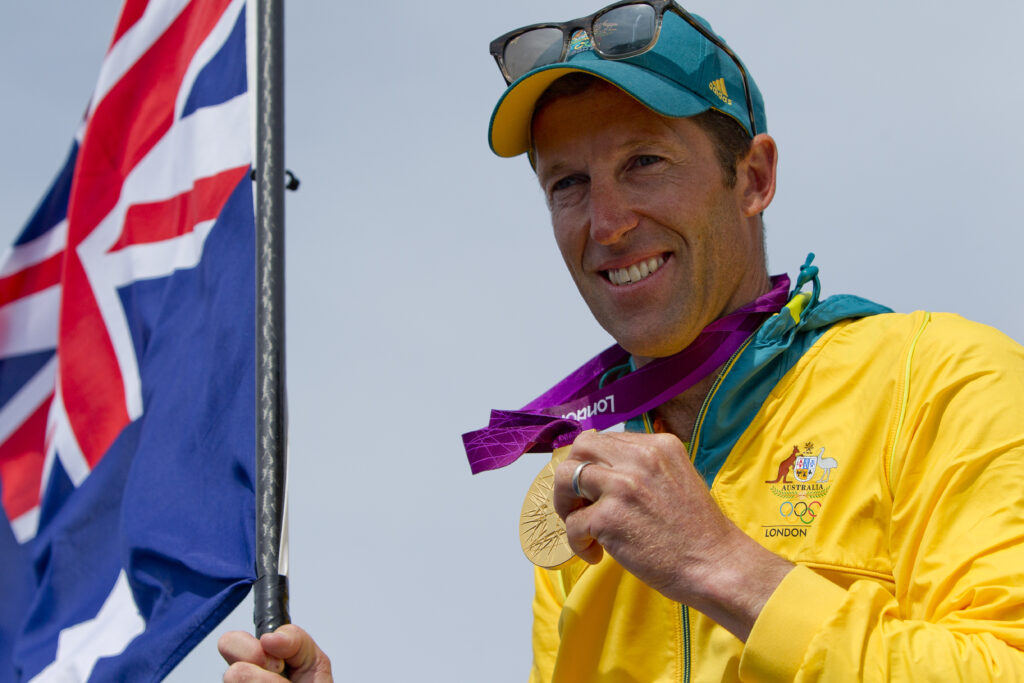 Malcolm Page holding Gold medal.