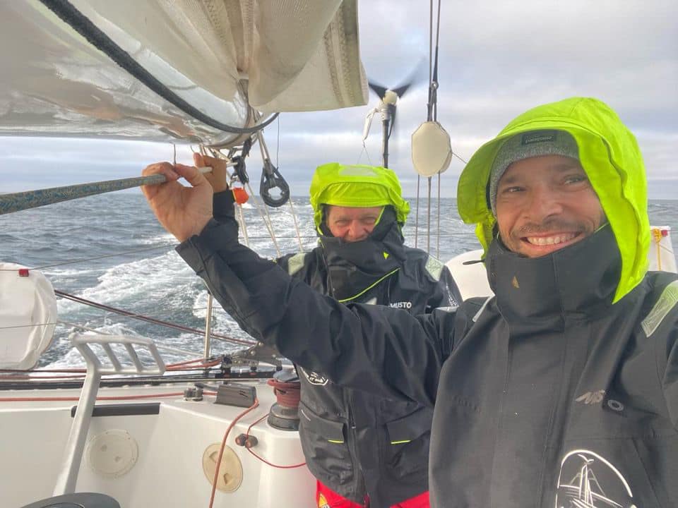 Two sailors in wet weather gear.