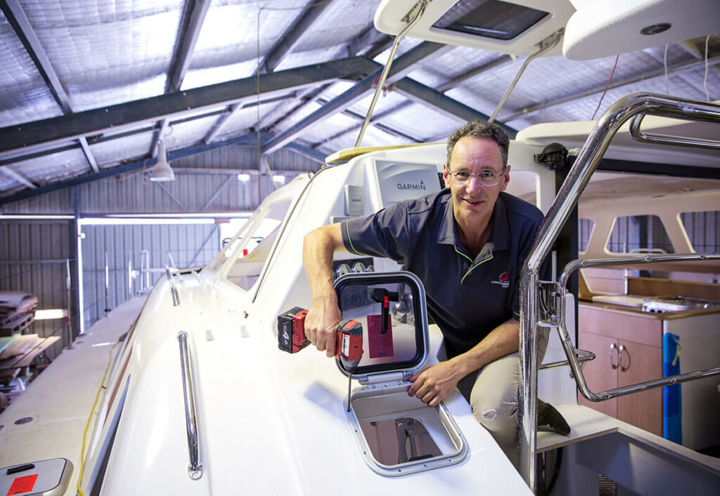 Roger, drilling in atop hatch on a boat while in the hard stand in a shed.