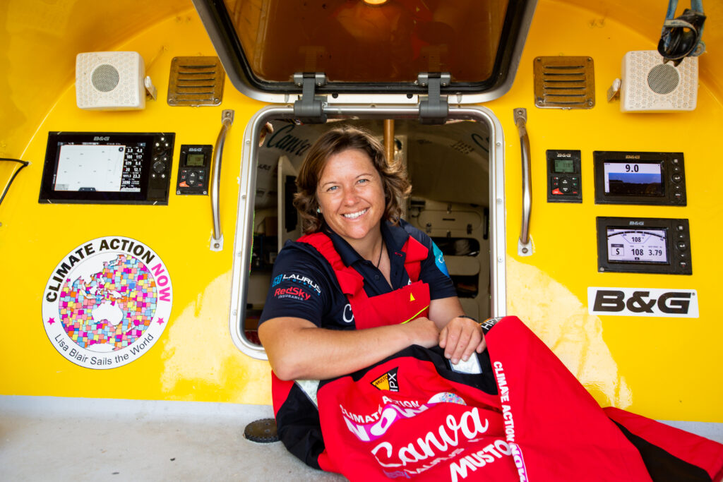 Lisa Blair smiling through the hatch leading to the boat cabin.