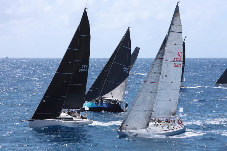 Fleet sailing upwind on different tacks.