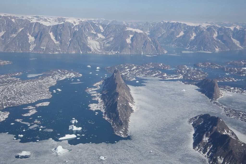 Renland, Greenland. Snowy mmountains surrounded by snow/ice and water.